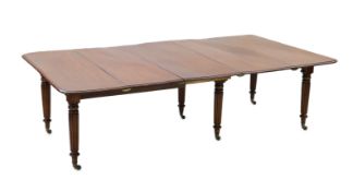 A Regency mahogany extending dining table, with rounded rectangular top and four leaves, on six
