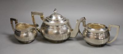 An early 20th century Chinese Export white metal three piece tea set, by Hung Chong?, with bone