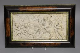 A framed ceramic relief plaque of classical scene with putti 16x31cm excl frame