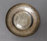 An engraved Middle Eastern? white metal dish with inset coin, 11.7cm, gross weight, 90 grams.