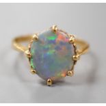 A modern 18ct gold and oval black opal set ring, size P/Q, gross weight 3.6 grams.