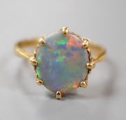 A modern 18ct gold and oval black opal set ring, size P/Q, gross weight 3.6 grams.