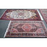 A North West Persian ivory ground rug, 220 x 140cm, and a smaller blue ground rug