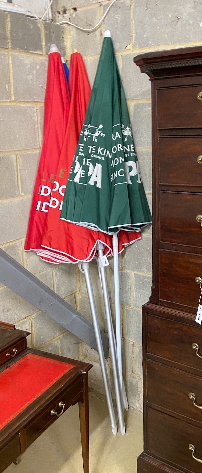 Four pub parasols with brewers branding