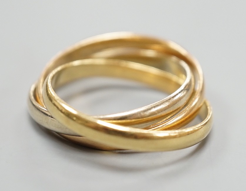 A modern Cartier three colour 750 yellow metal 'Russian' triple wedding ring, size U, 8.5 grams. - Image 2 of 5