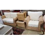 A contemporary rattan and natural fabric four piece conservatory suite, comprising settee, length