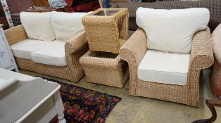 A contemporary rattan and natural fabric four piece conservatory suite, comprising settee, length