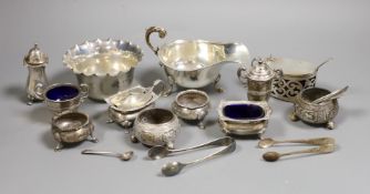 A small collection of mixed silver to include cased cutlery, a ladle, sauceboats, condiments, etc.