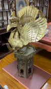 A large Indonesian brass Garuda figural oil lamp and a Islamic brass stand, 82cm tall