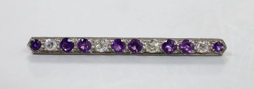 A white metal, eight stone amethyst and four stone diamond set bar brooch, 57mm, gross weight 4.6