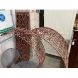 Three red painted wrought iron scrollwork garden arches, width 142cm, height approx. 250cm