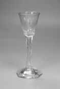 An 18th century facet stemmed glass with a petal foot,16.5 cms high,
