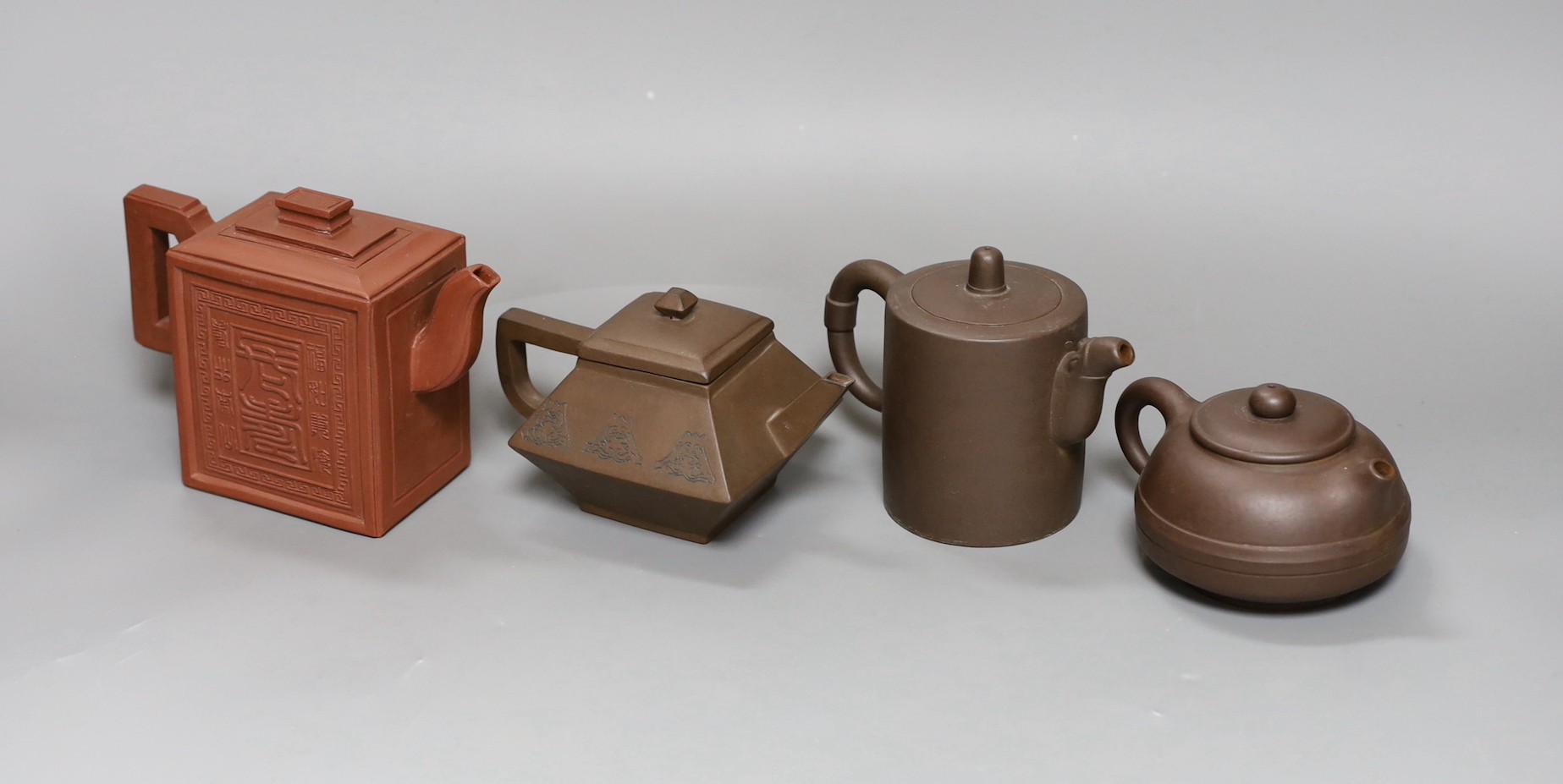 A Chinese Yixing rectangular teapot and three other Yixing teapots (4), Tallest 12 cms high,