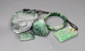 A group of five Chinese jadeite carvings, including two pendants and a bangle, largest 11cms long,