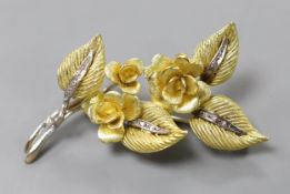 A 1960's two colour 18ct gold and diamond chip set floral spray brooch, maker CJ Ltd, 62mm, gross