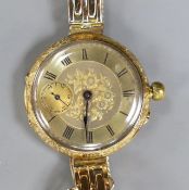 An early 20th century engraved 18ct gold fob watch, now converted to a wrist watch on a later