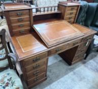 A late Victorian mahogany pedestal desk with hinged slant front, width 137cm, depth 73cm, height