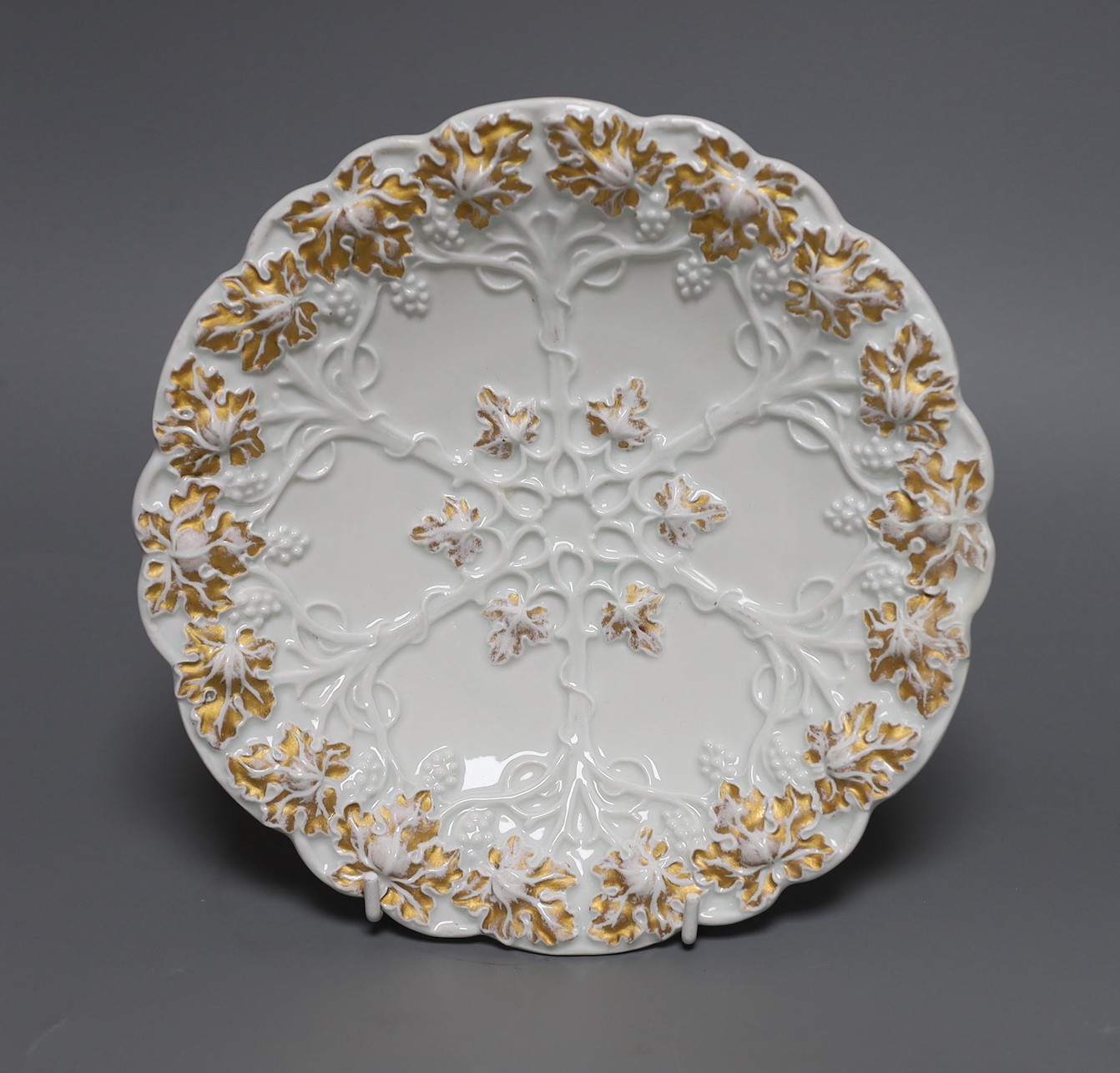 A Mesissen gilt decorated moulded dish,21.5 cms diameter,
