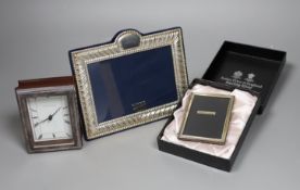 Two modern silver mounted photograph frames and a similar silver mounted Mappin & Webb timepiece,