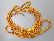 Three assorted amber bead necklaces, longest 112cm, gross weight 115 grams.