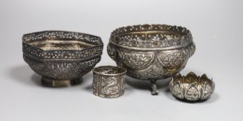Two early 20th century Indian repousse white metal bowls, widest 12cm, a similar small dish and a