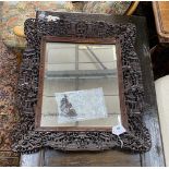A Chinese rectangular carved hardwood wall mirror, width 52cm, height 64cm