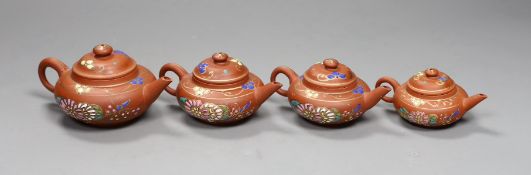 Four Chinese Yixing graduated enamelled miniature teapots,largest 5.5cms high,