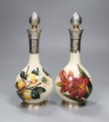A pair of Victorian silver mounted Art pottery scent bottles,21.5cms high including stopper,