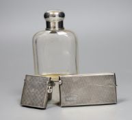 A German 800 standard white metal mounted glass hip flask, 14cm, a George V silver vesta case and