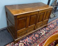 An 18th century panelled oak mule chest, initialled to the frieze A.B, altered, length 125cm,
