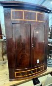 A George III banded mahogany hanging corner cabinet, width 82cm, height 126cm