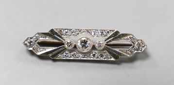 An Art Deco 18ct, plat and diamond cluster shaped bar brooch, with millegrain set stones, 37mm,