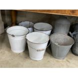 Ten galvanised and enamelled buckets, watering cans and feeder