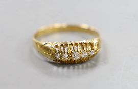An early 20th century 18ct gold and graduated five stone diamond chip set half hoop ring, size Q,