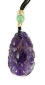 A Chinese amethyst pendant, 19th/20th century, carved in relief with peaches and leaves, 4.2cm