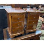A pair of reproduction cherry three drawer bedside chests with slides, width 43cm, depth 42cm,