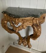A pair of 18th century style carved giltwood serpentine console tables with variegate green marble