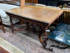 A late 19th / early 20th century French oak extending dining table, (one spare leaf) length 125cm,