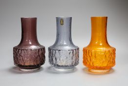 Three Whitefriars cylindrical bottle vases, in amethyst, tangerine and smoked glass, each 18cm