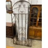 A pair of arched wrought iron gates, each gate width 85cm, height 187cm