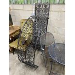 A black painted wrought iron scrollwork garden arch, width 142cm, height approx. 250cm