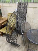 A black painted wrought iron scrollwork garden arch, width 142cm, height approx. 250cm