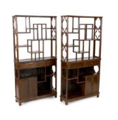 A pair of Chinese jichimu display cabinets, each with asymmetrical open shelves above two drawers,