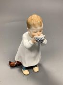 A Meissen figure of a child drinking from a bowl, modelled by Konrad Hentschel, c.1905-1924, 16cm