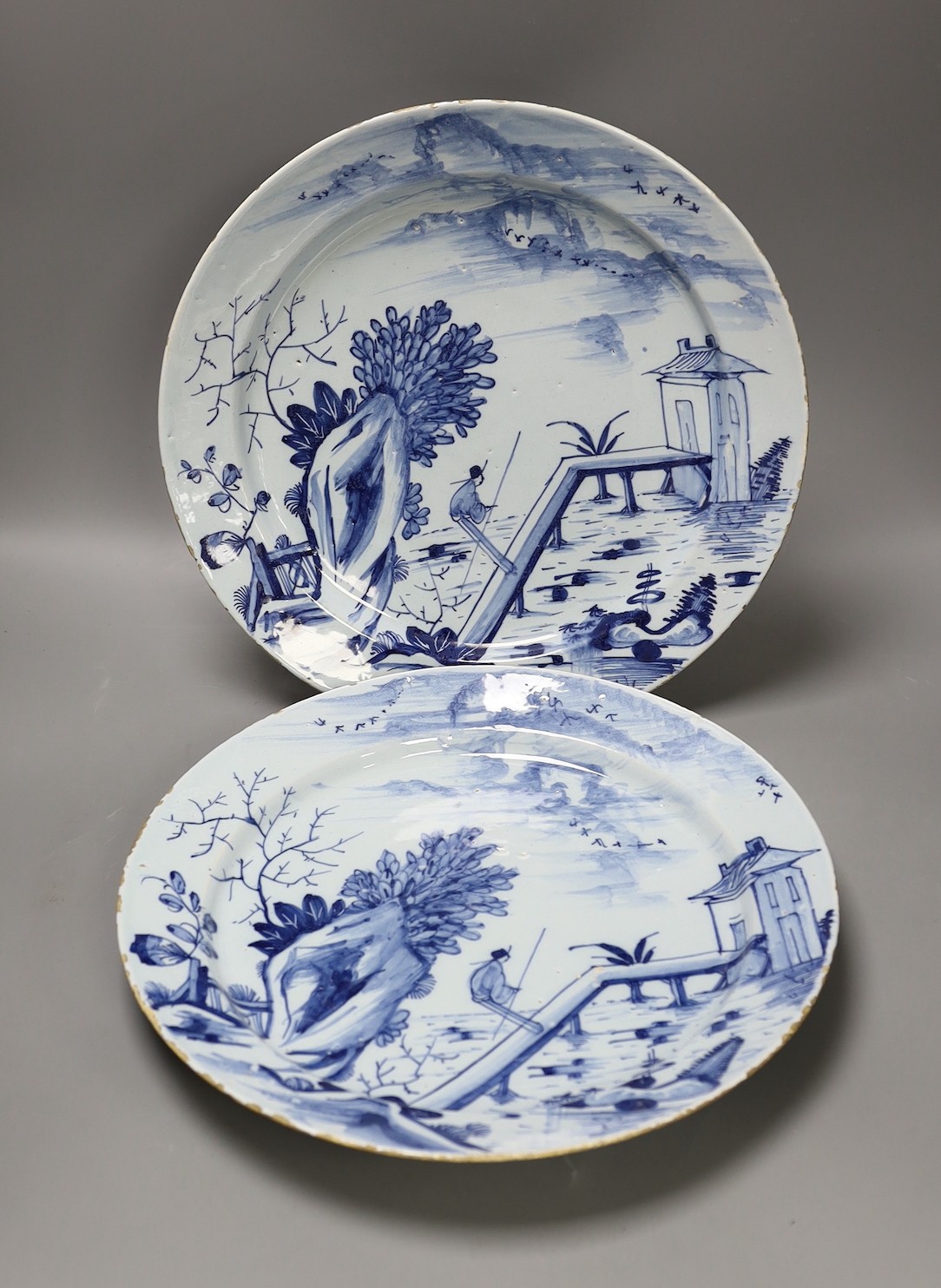 A pair of mid 18th century Delft blue and white chargers, 33.5cm diameter