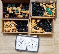 A collection of four wooden chess sets and a clock