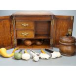 A carved smoker’s cabinet containing Meerschaum and other pipes and a tobacco jar,cabinet 25cm high