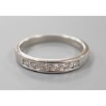 A modern platinum and channel set seven stone half hoop ring, size P, gross weight 5.1 grams,