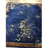 An early 20th century Chinese blue ground carpet woven with butterflies and flowering branches 450cm