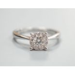 A modern 750 white metal and ten stone diamond set circular cluster ring size M, gross weight 3.3